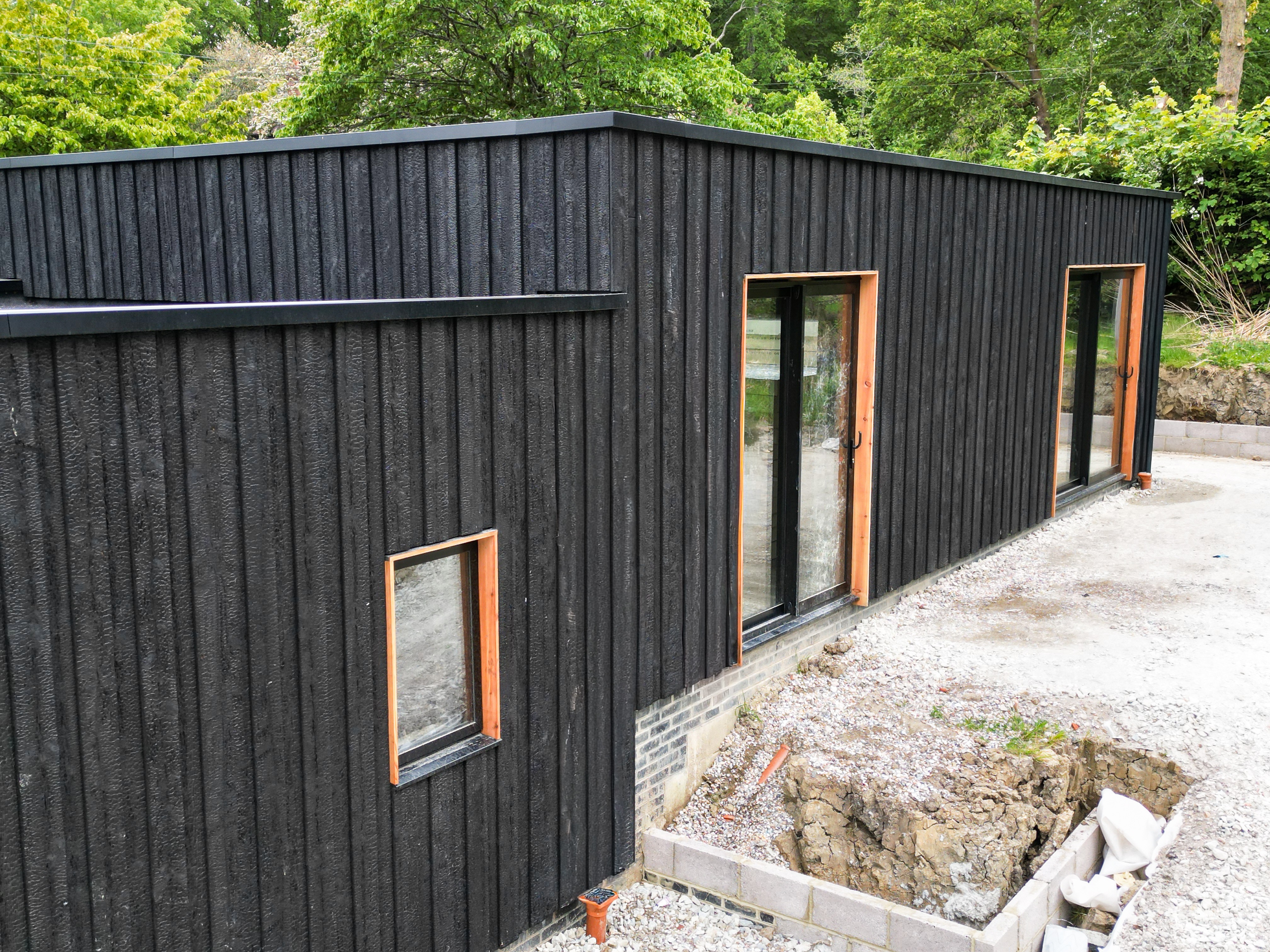 KAEN Carbon charred larch exterior cladding at Woodland Dwelling in KAEN Larch, East Sussex, East Sussex, UK